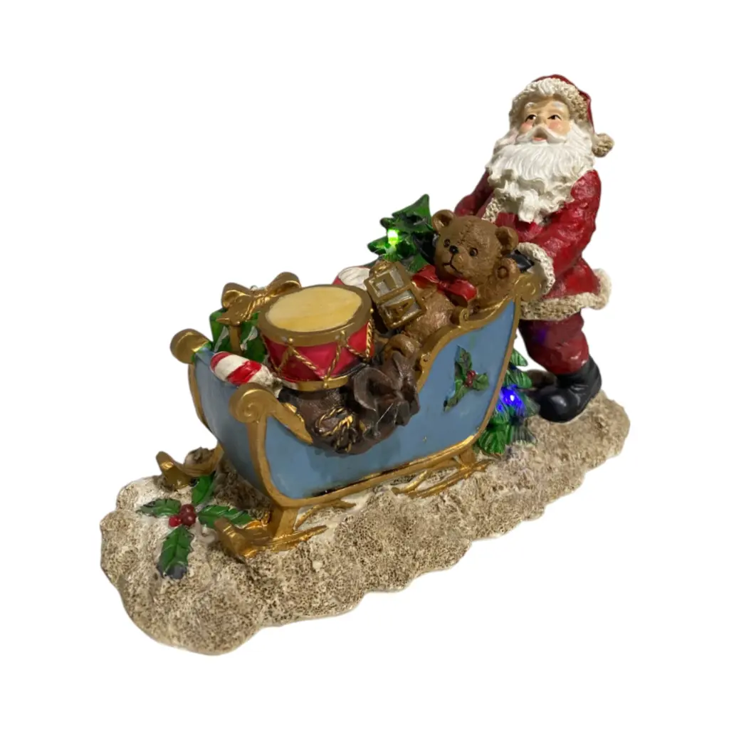Noel con trineo de juguetes, poliresina. Con luz led, 2 pilas AAA. Ref:LP60114 (27x11x19cm)